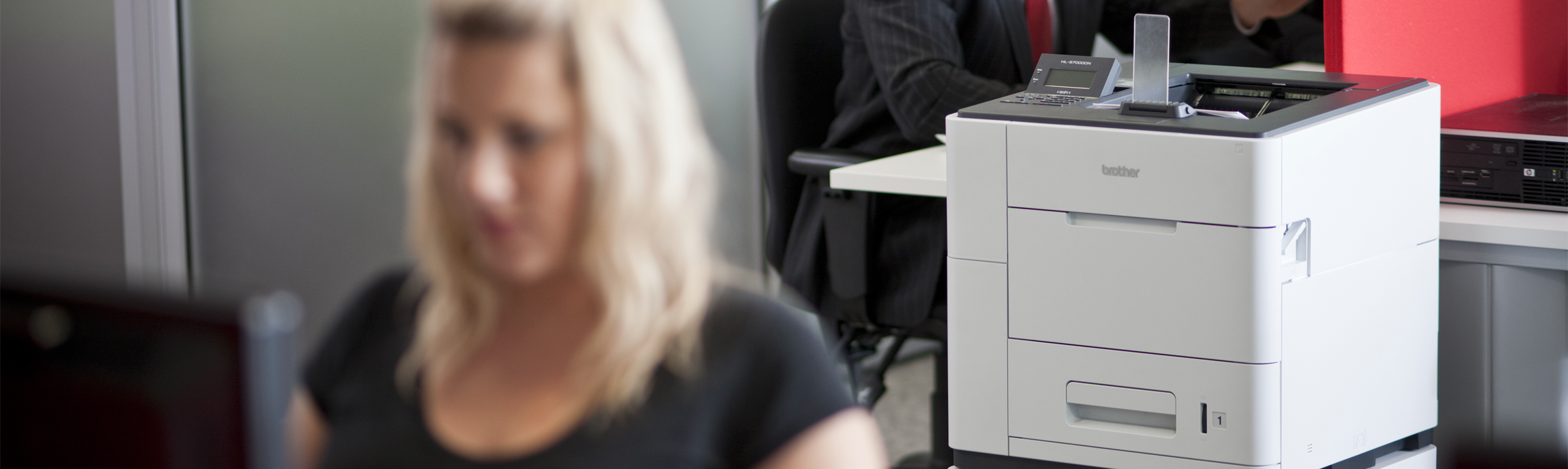 ragazza bionda al pc che stampa con Brother HL-S7000DN